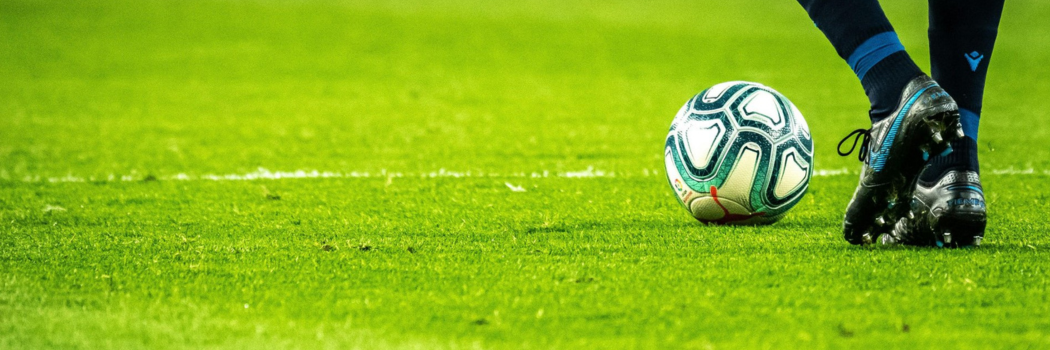 Soccer player with soccer ball on field