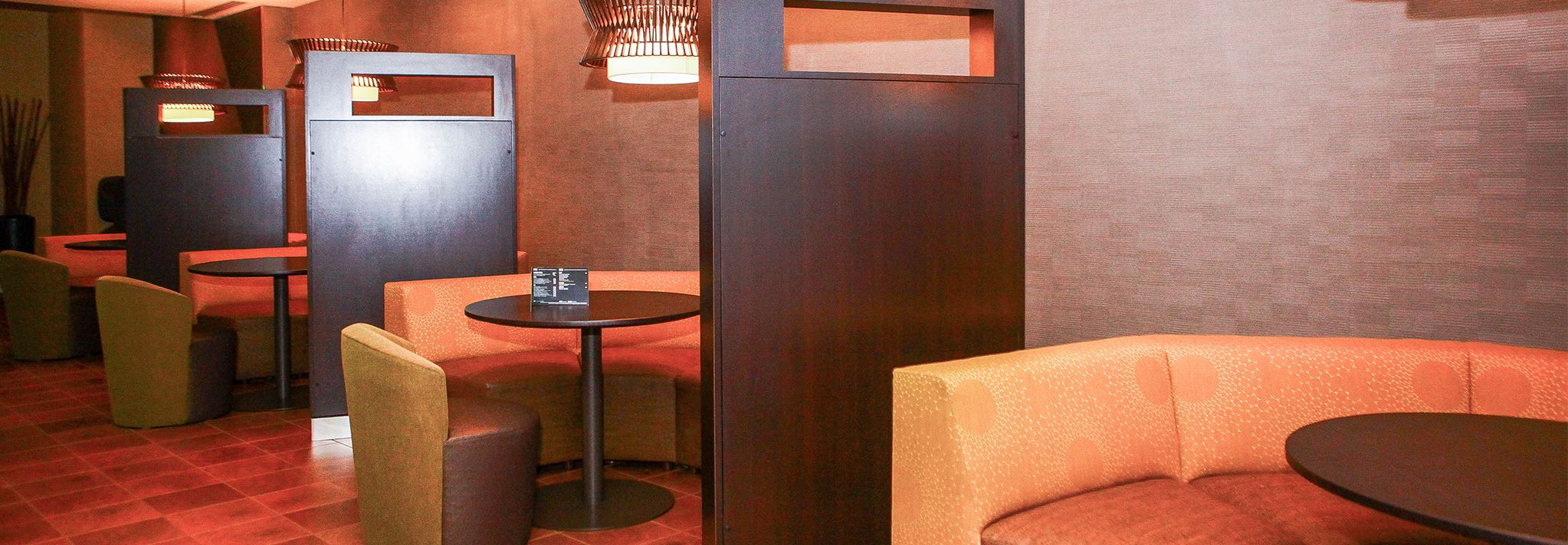 Orange booths with mood lighting in the Marriott's bistro